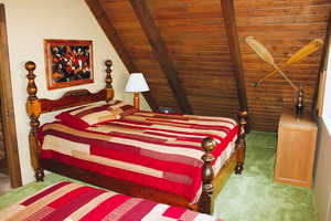 Carpeted bedroom featuring wood ceiling