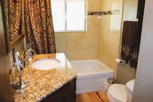 Bathroom with wood finished floors, toilet, and vanity
