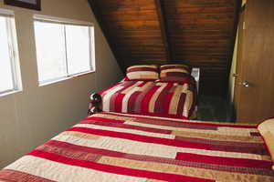 Bedroom featuring lofted ceiling