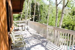 Wooden deck with view of wooded area