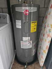 Utility room with water heater and washer / dryer