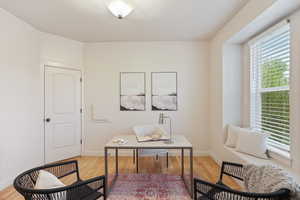Office area featuring baseboards and wood finished floors