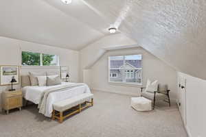 Bedroom featuring carpet, vaulted ceiling, and baseboards