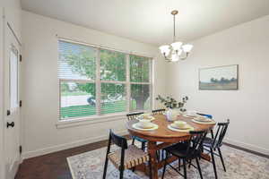 Dining room with an inviting chandelier, baseboards, and a healthy amount of sunlight