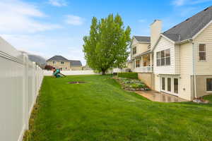 View of yard featuring a patio area, french doors, a residential view, a fenced backyard, and a playground