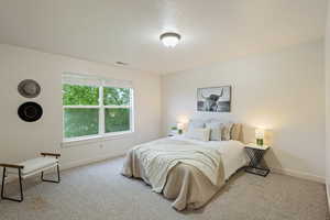 Carpeted bedroom featuring baseboards