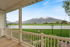View of patio with a fire pit, a mountain view, and a fenced backyard
