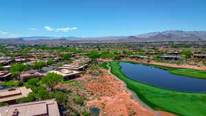 Aerial view with view of golf course, a residential view, and a water and mountain view
