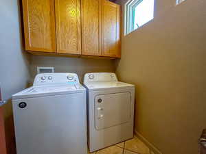 Washroom with cabinet space, washing machine and dryer.