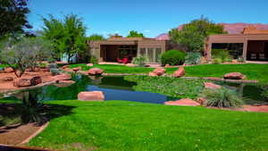 View of yard with a small pond