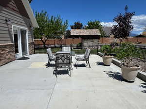 View of patio featuring fence