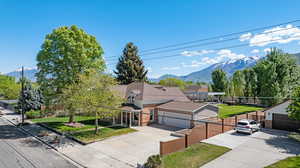 View of front of house with driveway and a mountain view