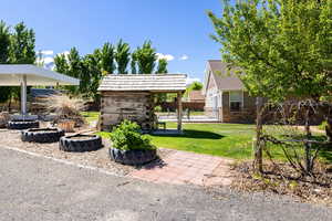 View of yard featuring a fire pit and an outdoor structure