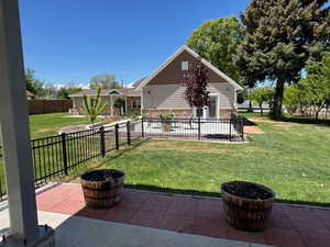 Back of property with a patio and stone siding