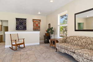 Living room featuring baseboards and recessed lighting