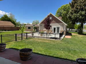 Back of house with a patio area and a chimney