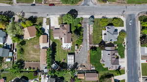 Aerial view of property and surrounding area featuring nearby suburban area