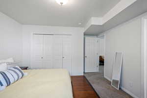 Bedroom featuring a closet, baseboards, and carpet flooring