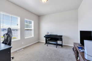 Carpeted office space featuring baseboards