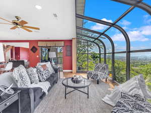 Living room with a sunroom, ceiling fan, wood finished floors, and recessed lighting