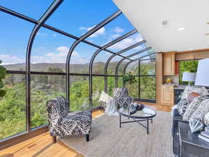 Sunroom / solarium with a mountain view and outdoor lounge area