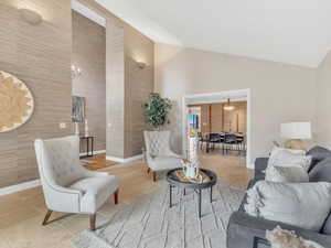 Tiled living room featuring baseboards and high vaulted ceiling