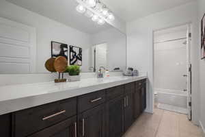 Full bath featuring tile patterned floors, vanity, toilet, and shower / tub combination