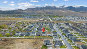 Aerial view of property's location featuring a mountain backdrop and nearby suburban area