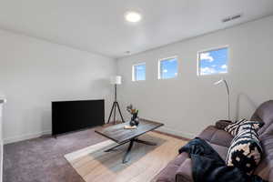 Living area with baseboards and carpet flooring