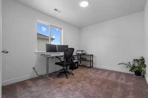 Carpeted office with baseboards