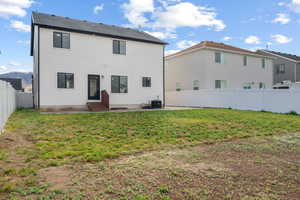 Back of house featuring central AC, a patio, entry steps, and stucco siding