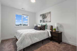 Carpeted bedroom with baseboards