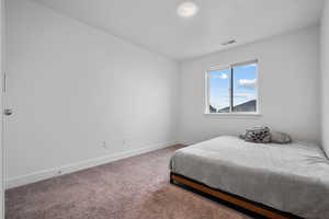 Carpeted bedroom featuring baseboards