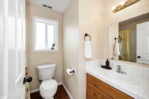 Upstairs Bathroom featuring tub/shower combo, toilet, baseboards, tile patterned floors, and vanity