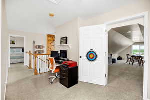 Office area with carpet floors, lofted ceiling, and baseboards