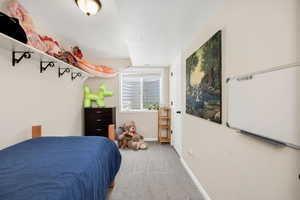 Basement Carpeted bedroom featuring baseboards