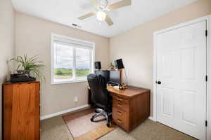 Office space/Bedroom with baseboards, a ceiling fan, and light colored carpet