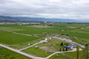 Aerial overview of property's location featuring rural landscape and a mountainous background