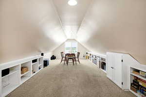 Bonus room featuring carpet floors and vaulted ceiling (not included in square footage)