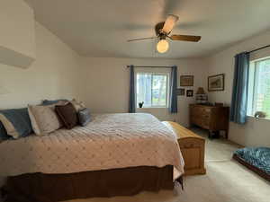Bedroom featuring light carpet and a ceiling fan