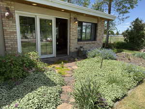 Doorway to property featuring brick siding