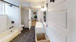 Full bathroom featuring toilet, tile patterned floors, and vanity