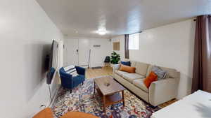 Living area featuring light wood finished floors and a textured ceiling