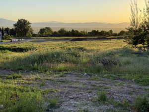 View of mountain backdrop featuring rural landscape