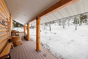 Snow covered deck with covered porch