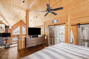 Bedroom featuring a barn door, wood ceiling, wooden walls, wood-type flooring, and lofted ceiling