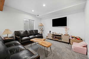 Carpeted living area featuring recessed lighting