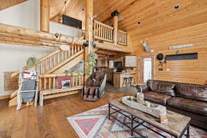 Living area featuring high vaulted ceiling, wooden ceiling, and hardwood / wood-style floors
