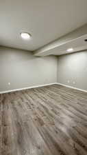 Finished below grade area with wood finished floors and baseboards