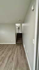 Stairway featuring wood finished floors and baseboards